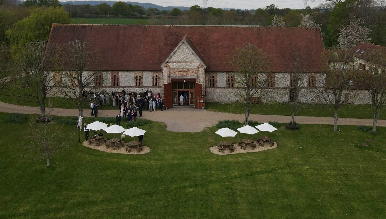 Aerial view of The Tithe Barn in Petersfield, Hampshire, capturing the charm and beauty of a wedding celebration from above