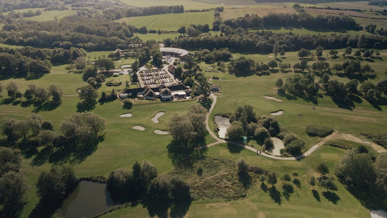 Aerial view of Sandford Springs in Hampshire during a beautiful wedding day. The stunning drone shot captures the elegance of the venue and the joyous celebration unfolding below