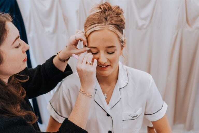 Bride having her make up finished during bridal preparations