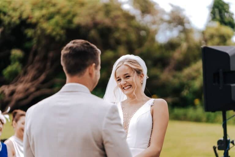 Bride laughing with the groom during the first dance
