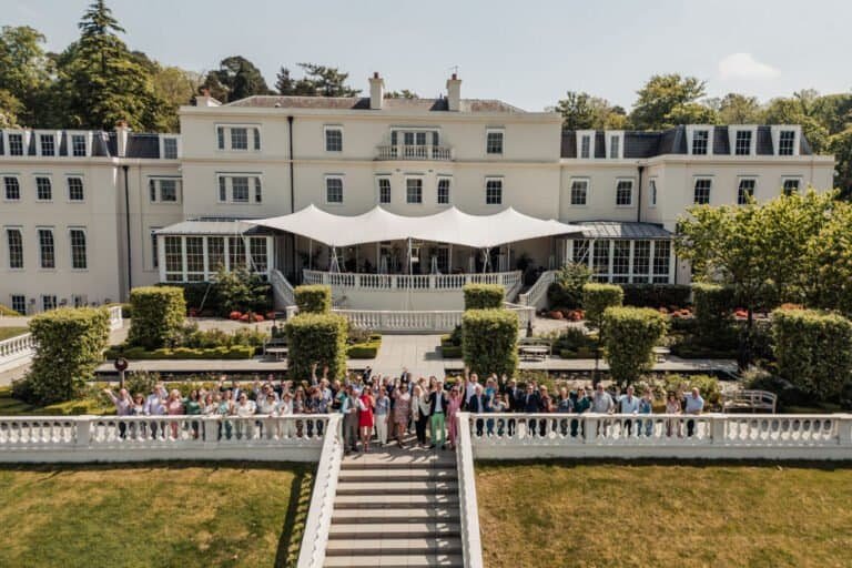 Country house venue with guests gathered on the terrace for a corporate awards day