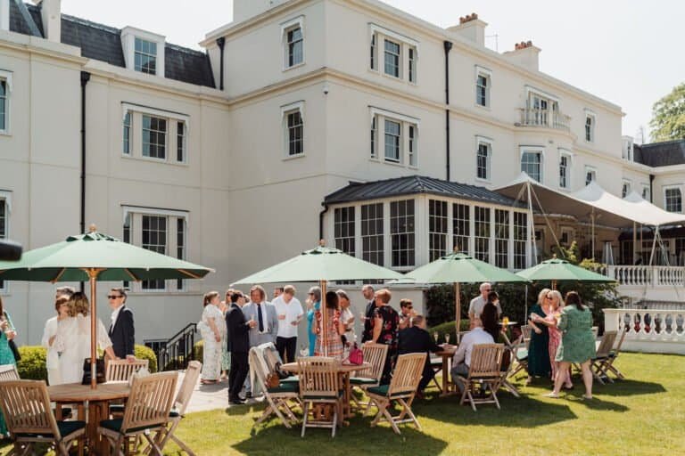 Guests at a summer drinks reception on the terrace