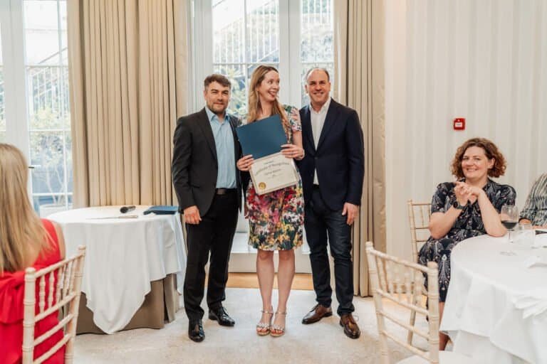 Employee receiving a long service award in front of colleagues