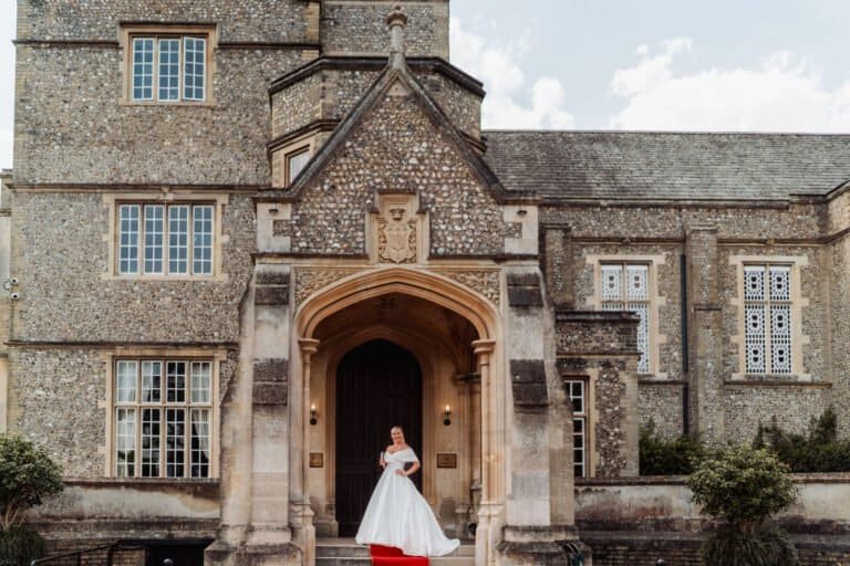 Bride at the gothic stone entrance to Horsley Towers