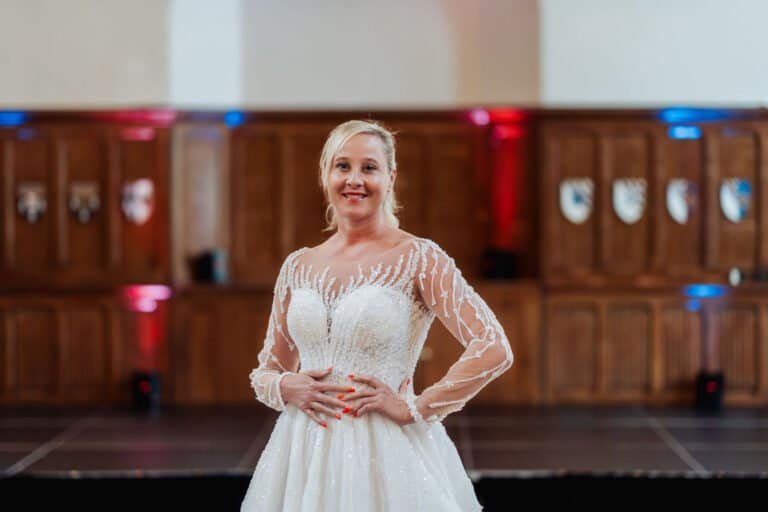 Wedding dress photographed in the heraldic panelled hall at Horsley Towers