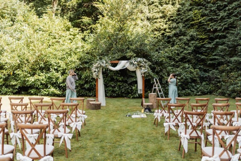 Outdoor ceremony arch and seating set up in the grounds at Kingswood Manor