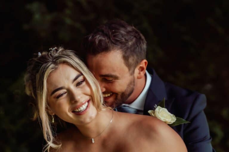 Bride laughing close to the groom during their portraits