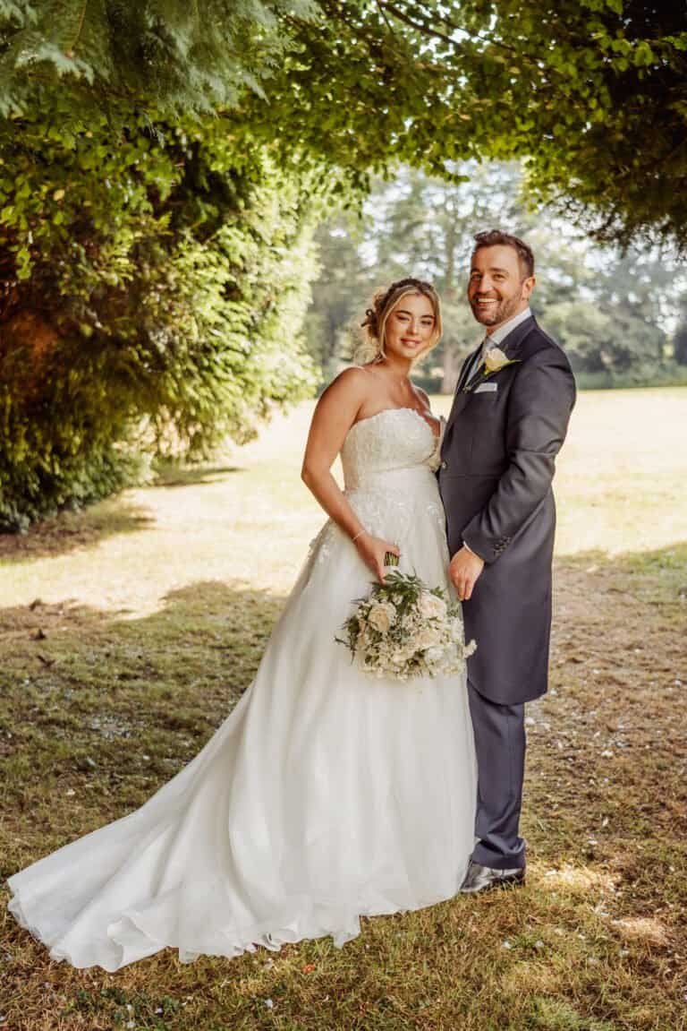 Full length portrait of the bride and groom in golden evening light