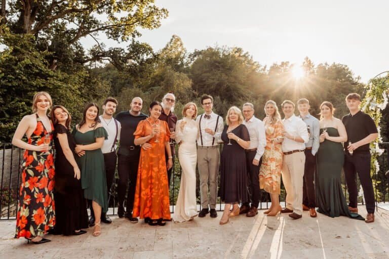 Wedding guests photographed together in low evening sunlight