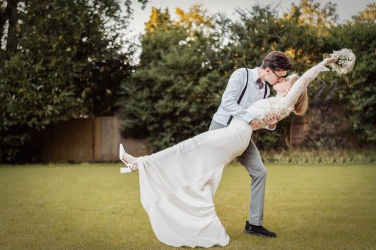 Couple kissing with their shadows thrown across a brick wall