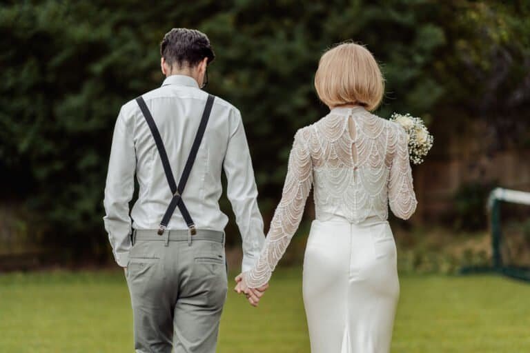 Bride laughing as the groom holds her from behind
