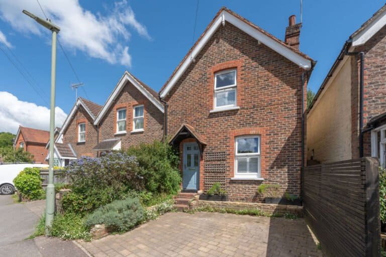 Front elevation of a brick family house on a quiet residential road