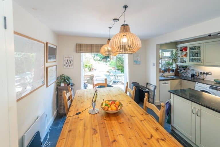 Open plan dining area with pendant lighting above the table
