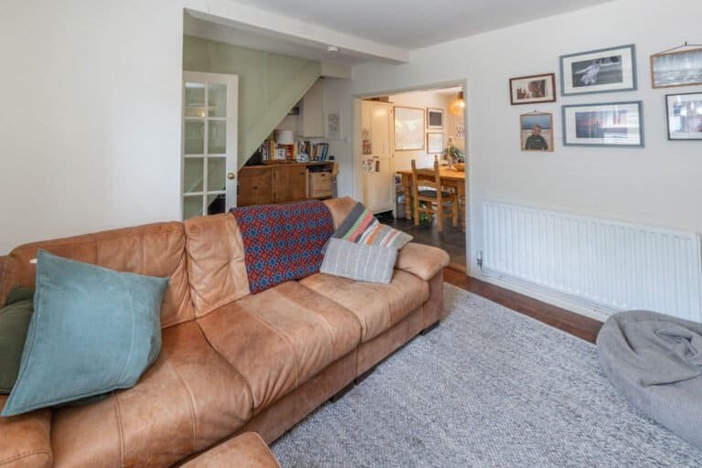 Bright living room with sofa and garden view beyond