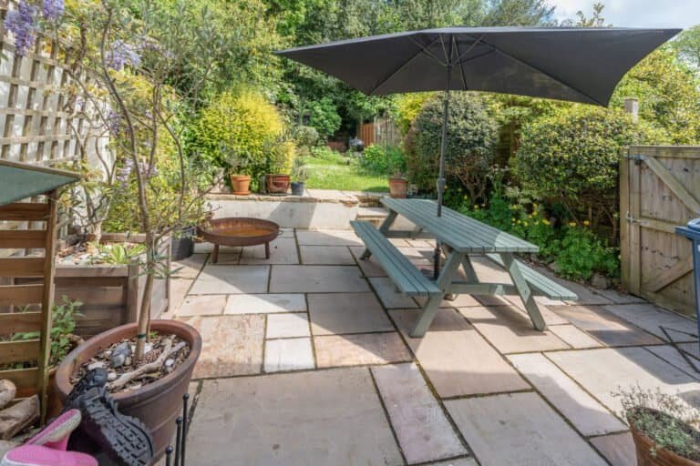 Landscaped rear garden with patio seating and mature planting