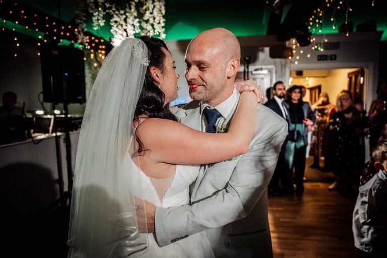 First dance with the bride's veil lifting as the couple turn